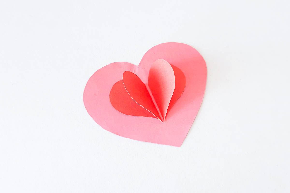Folding heart pieces into each other.