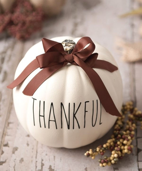 cricut thanksgiving pumpkin craft, creamy pumpking with the word "thankful" printed on it