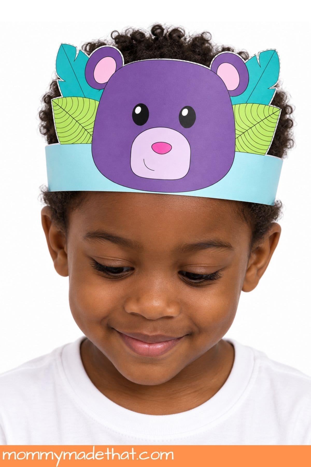 Child wearing a purple bear crown with teal and lime leaves and a turquoise band