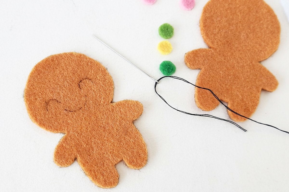 drawing face on gingerbread man head.