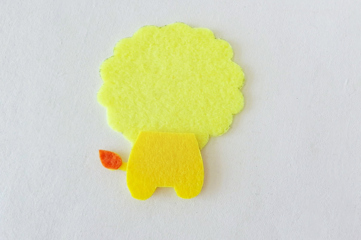 Yellow lower-body piece aligned with the lion’s back and legs