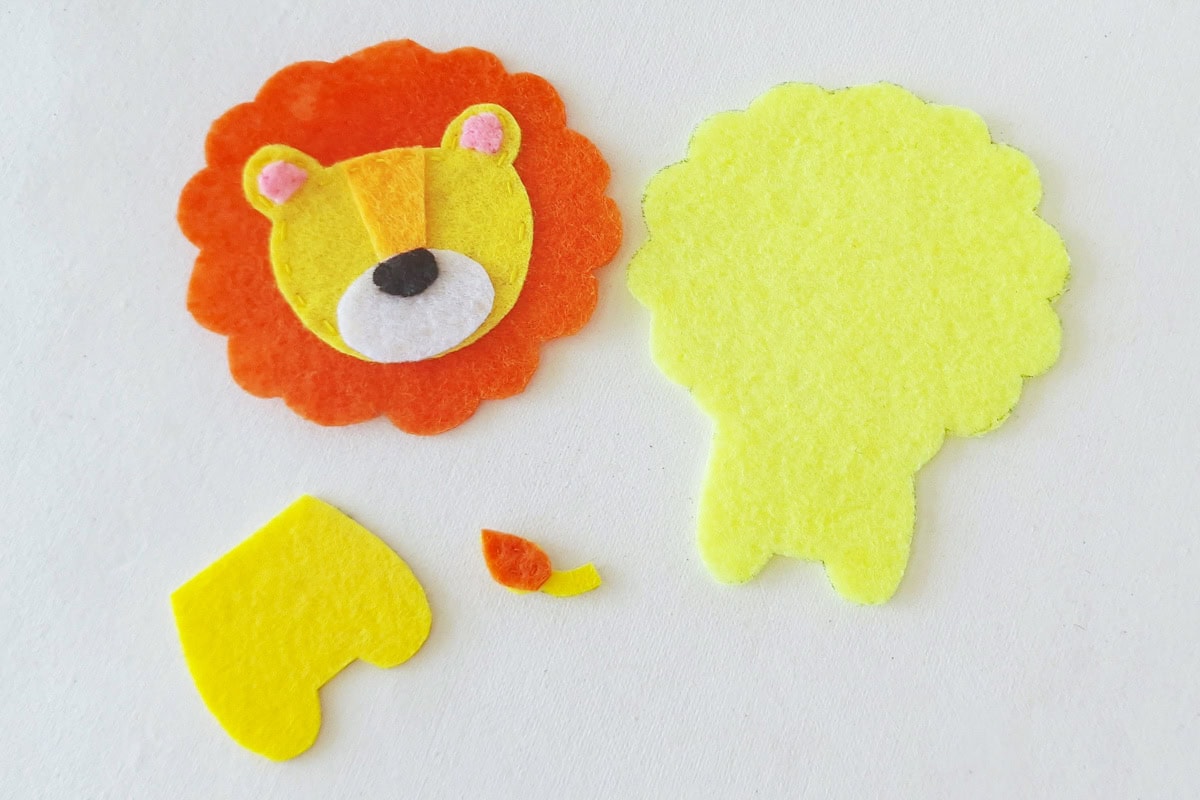 Lion face and mane beside the body base, lower body, and felt tail pieces