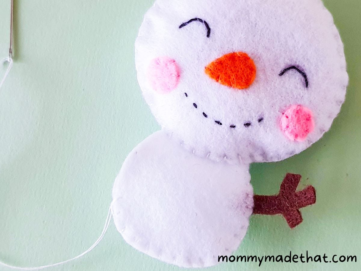 Stitching side of snowman's body.