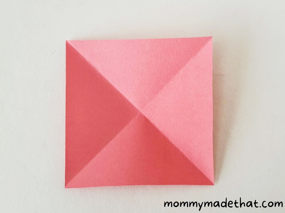 square piece of paper folded diagonally again
