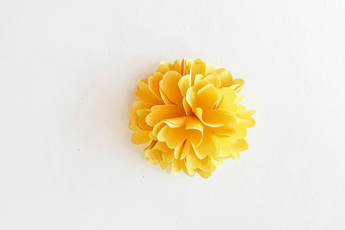 Formed marigold flower from paper petals.