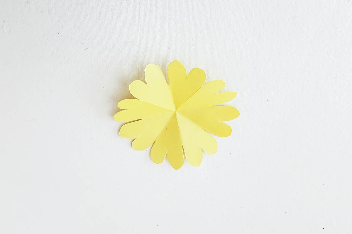 Opening up cut paper.