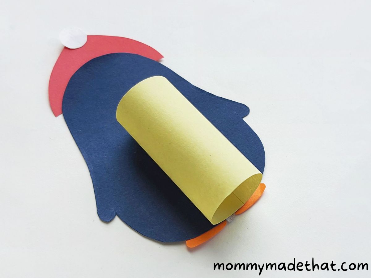 attaching rolled up paper to penguin