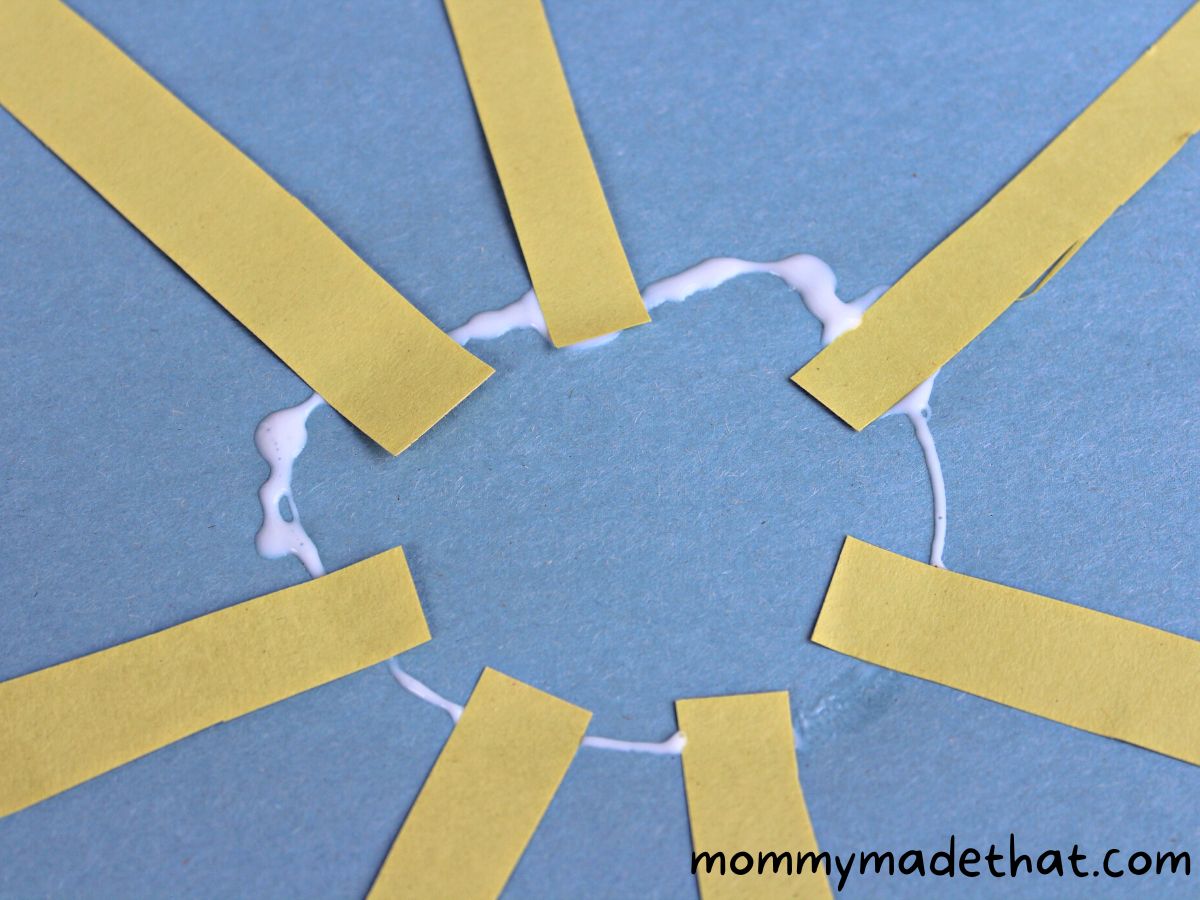 adding yellow strips to circle of glue