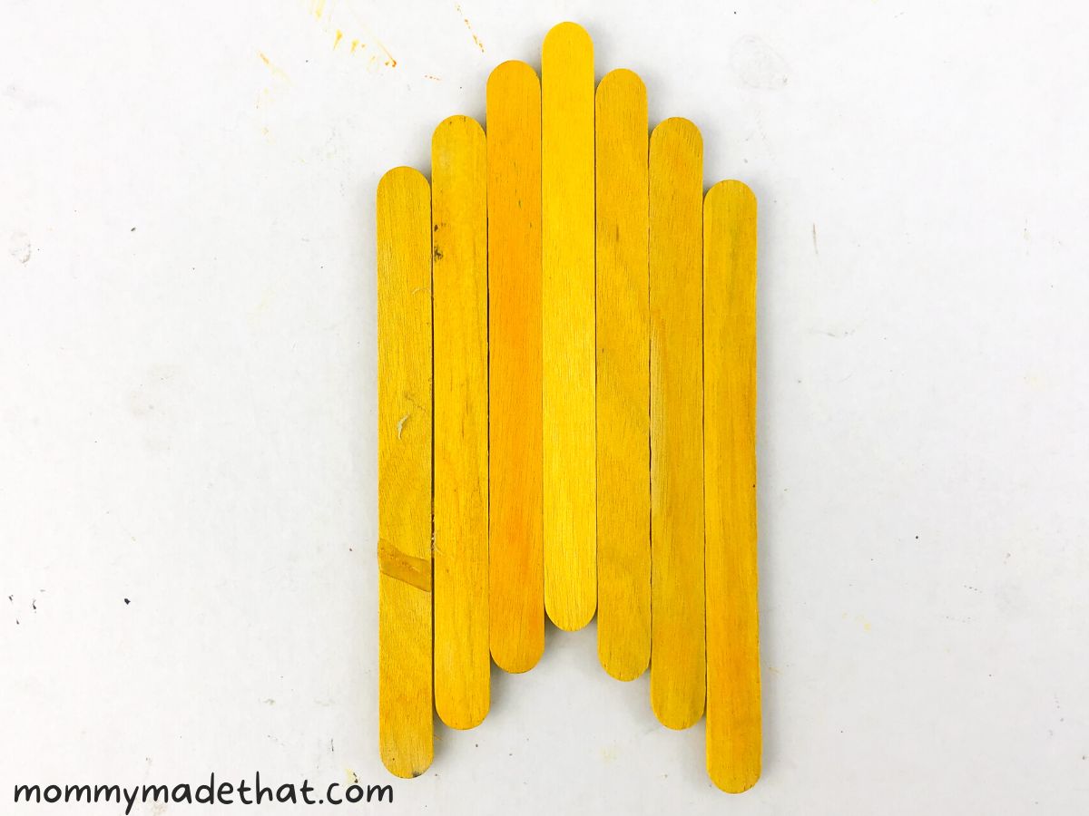 yellow popsicle sticks lined up