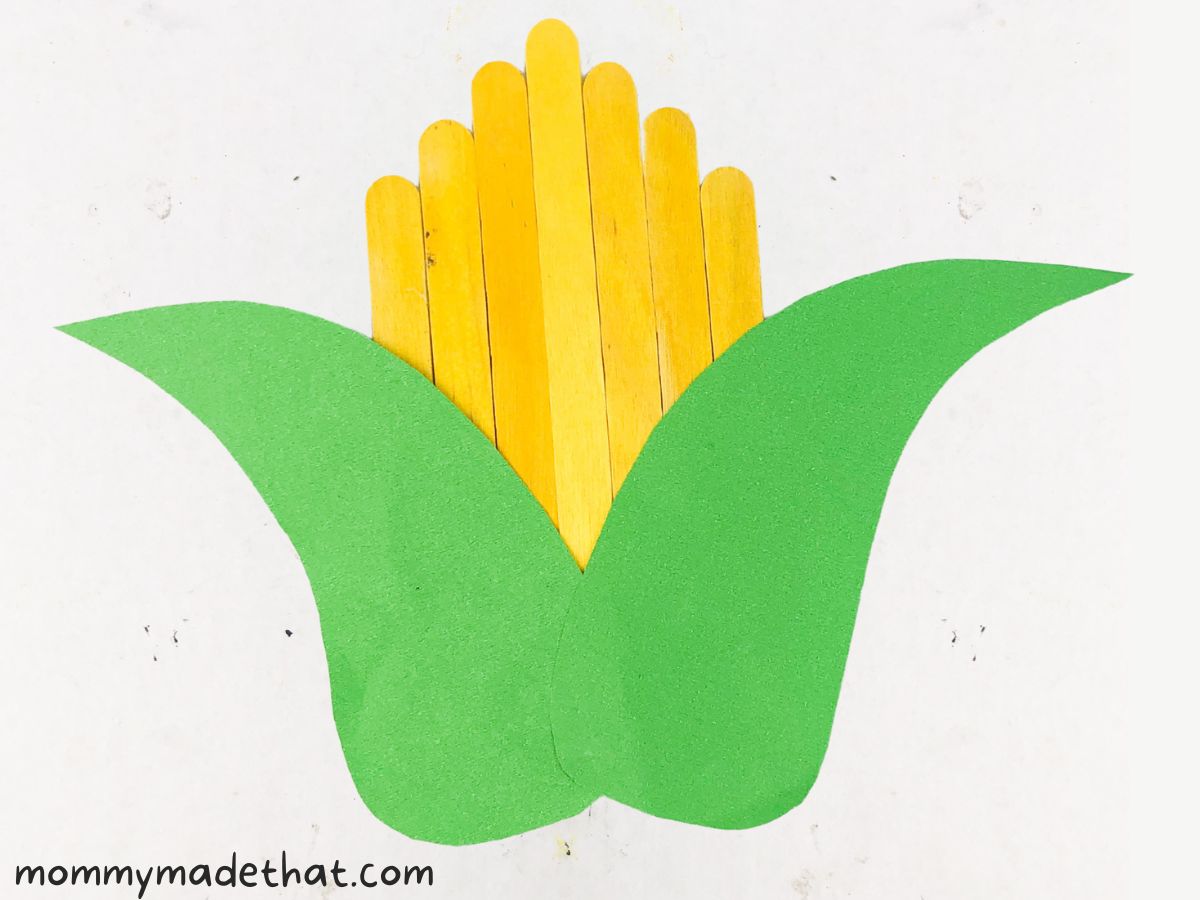 attaching paper corn husks to corn cob craft