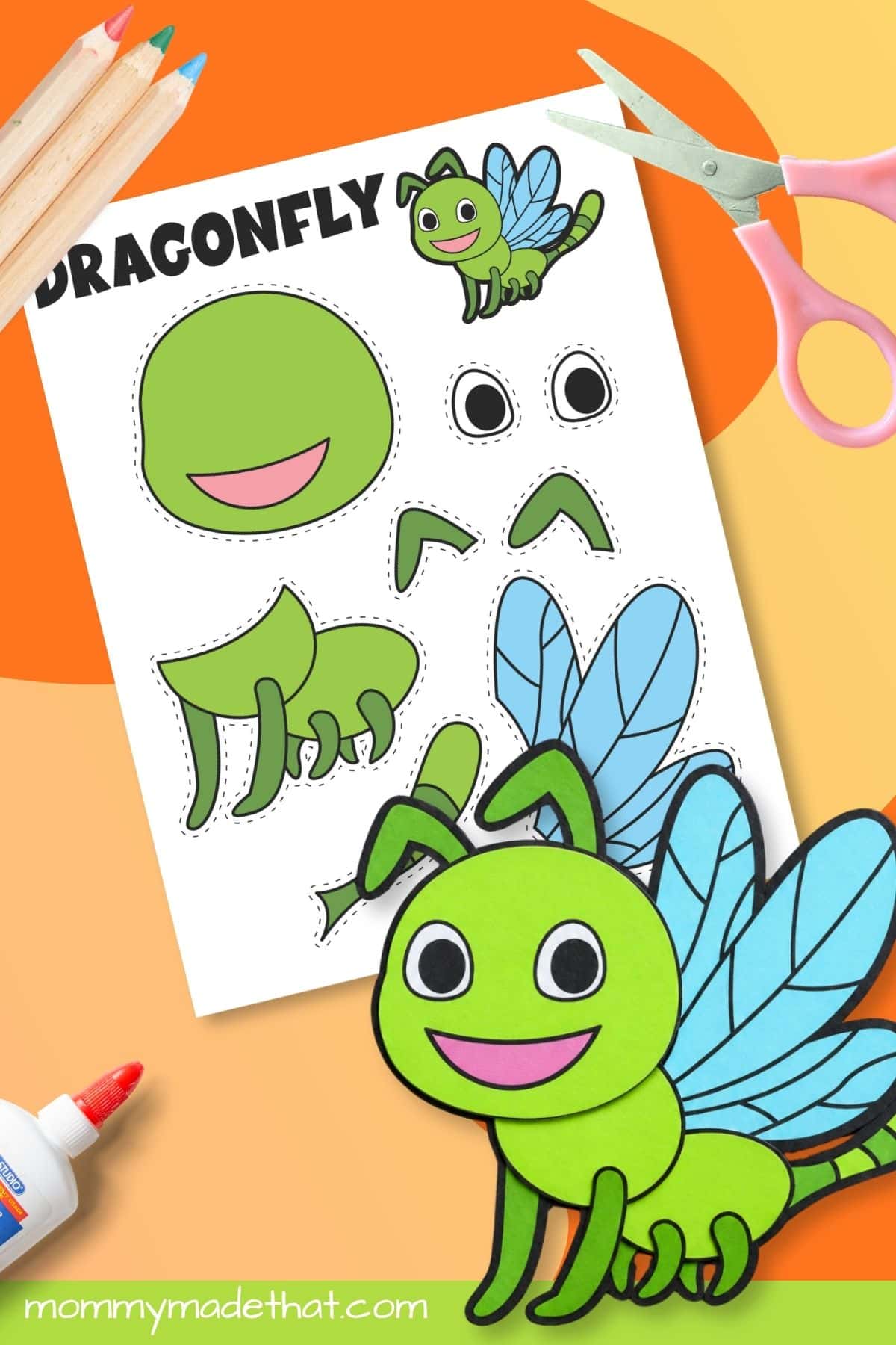 Assembled dragonfly printable craft beside scissors and template