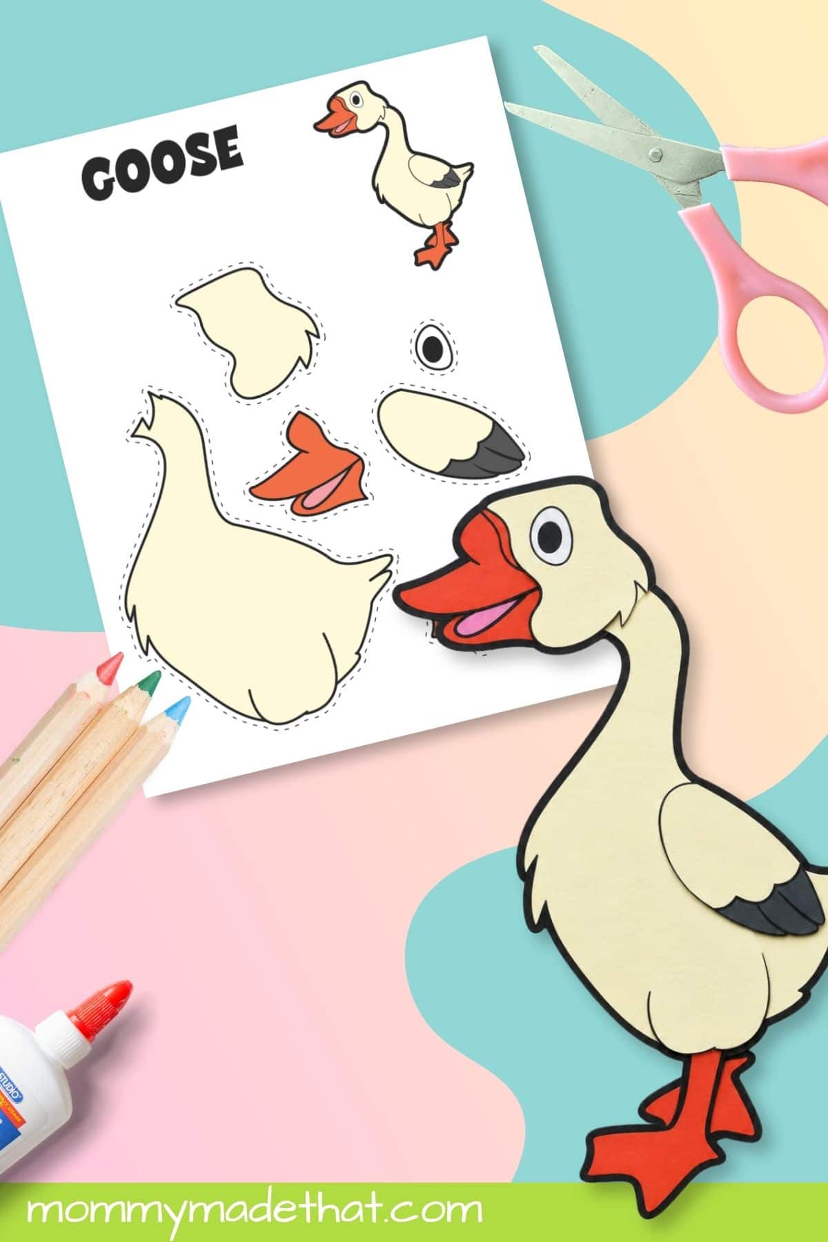 Assembled goose printable craft beside scissors and template