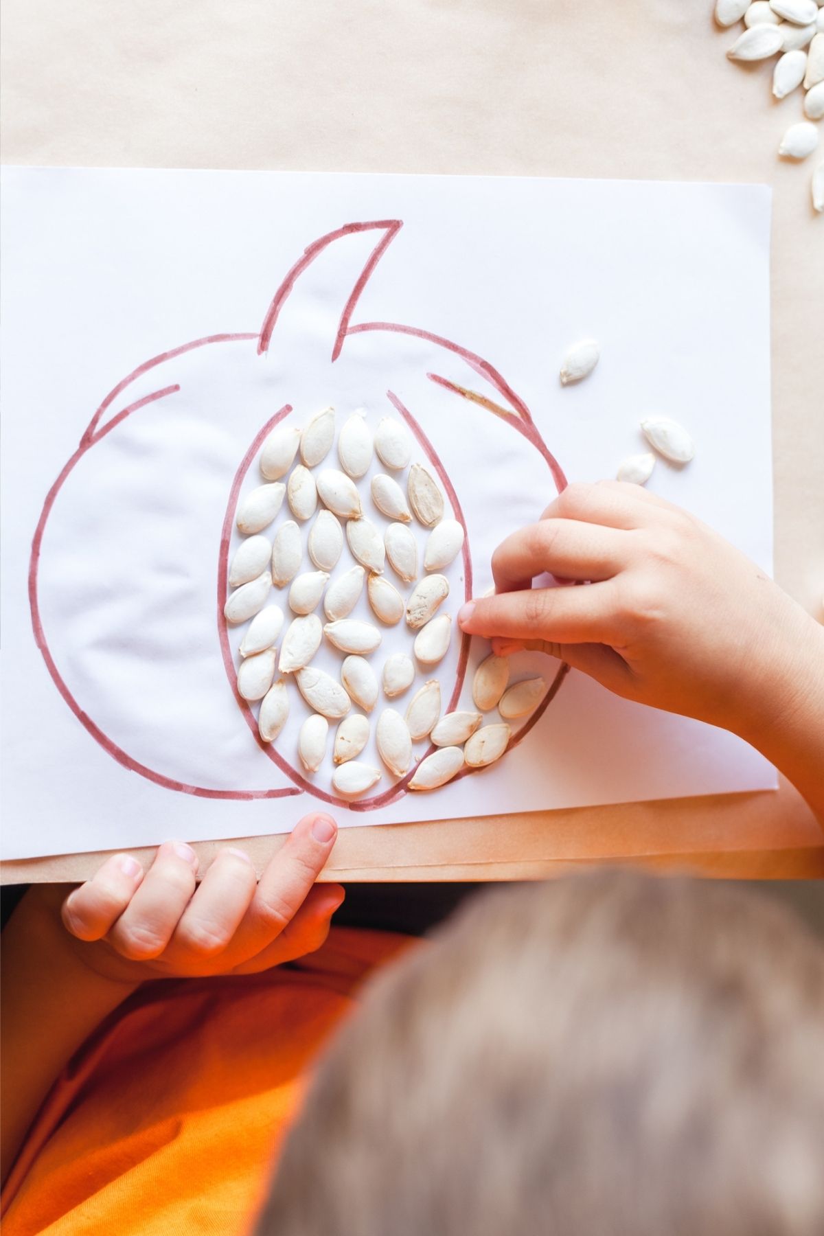 pumpkin outline filled with pumpkin seeds