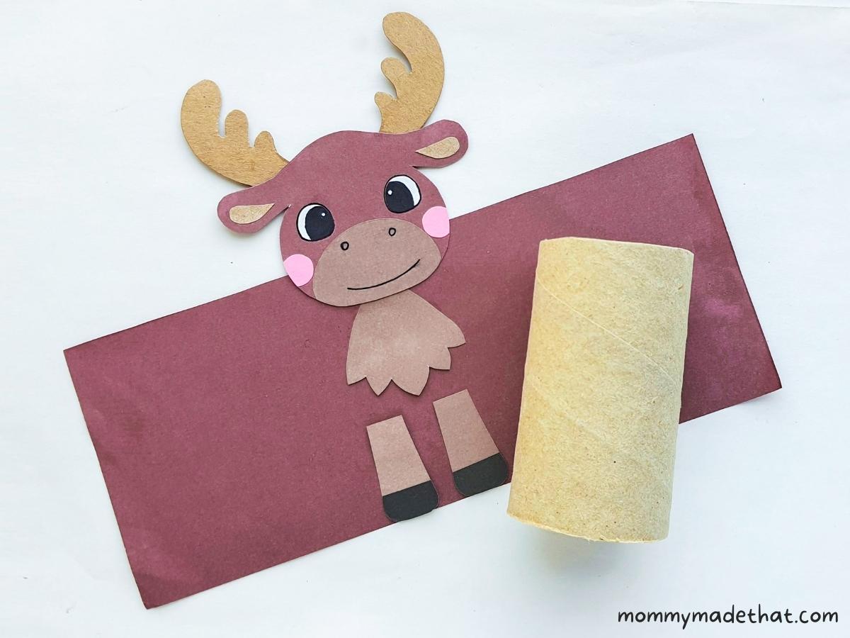 assembling paper moose craft to toilet paper roll